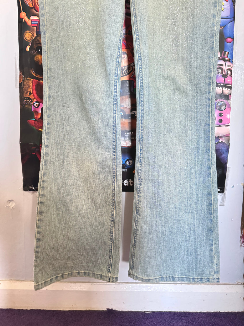 y2k vintage mid waisted light wash denim flared jeans with buckle and shimmer throughout
