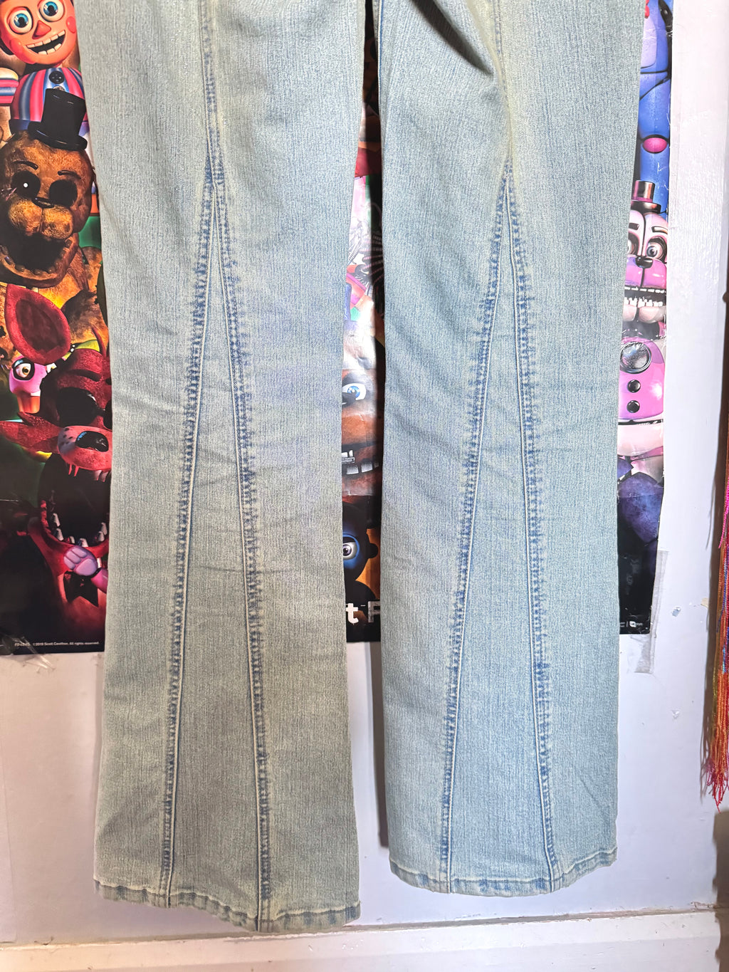 y2k vintage mid waisted light wash denim flared jeans with buckle and shimmer throughout