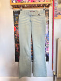 y2k vintage mid waisted light wash denim flared jeans with buckle and shimmer throughout