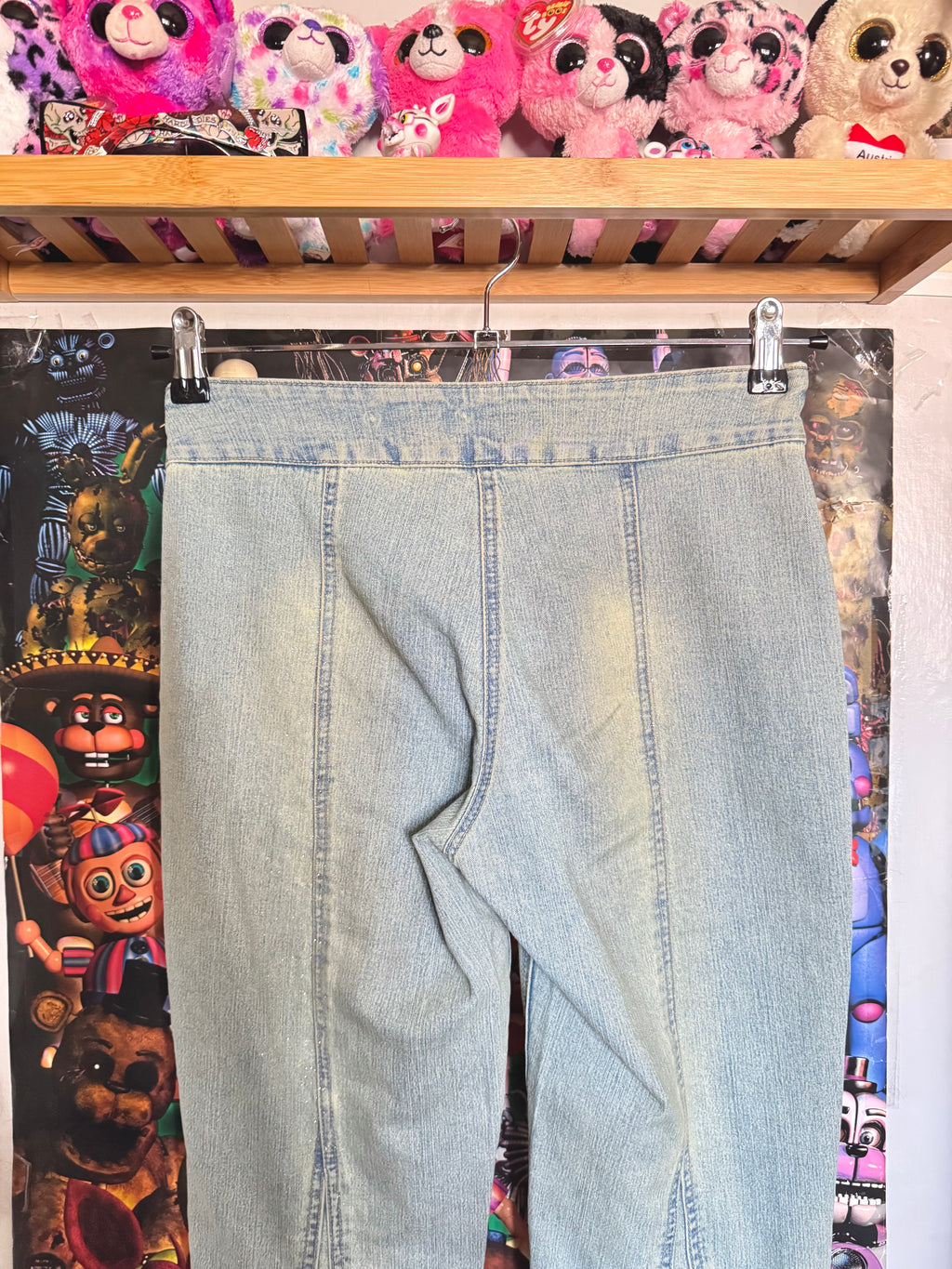 y2k vintage mid waisted light wash denim flared jeans with buckle and shimmer throughout