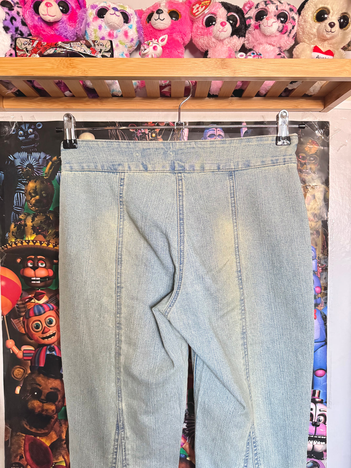 y2k vintage mid waisted light wash denim flared jeans with buckle and shimmer throughout