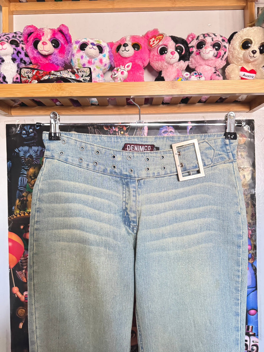 y2k vintage mid waisted light wash denim flared jeans with buckle and shimmer throughout