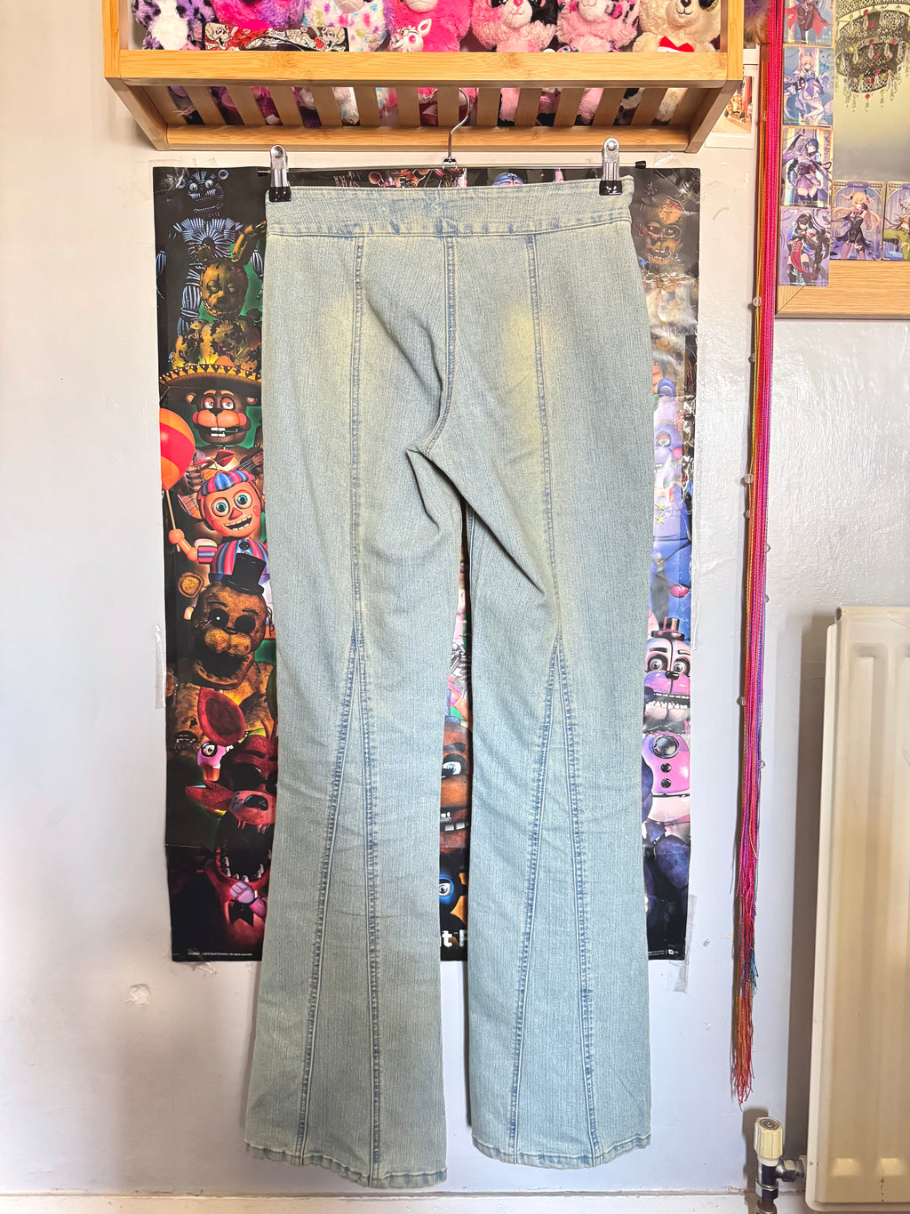 y2k vintage mid waisted light wash denim flared jeans with buckle and shimmer throughout